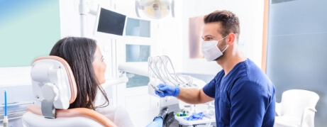 Dentist talking to a patient in the dental chair