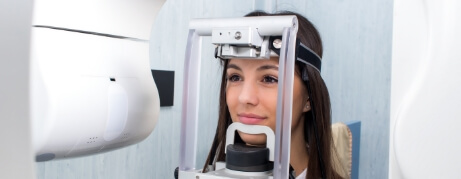 Woman getting C T cone beam scans of her mouth