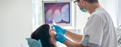 Dentist showing a patient images of their teeth