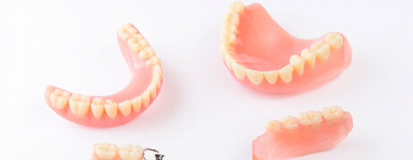 Sets of dentures against a white background