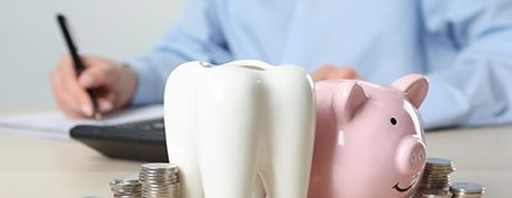 Coins next to a piggy bank