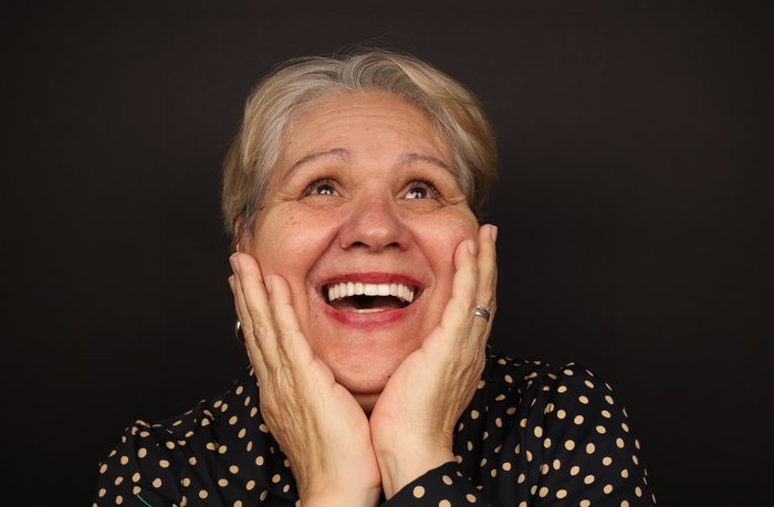 Excited patient showing off her new smile