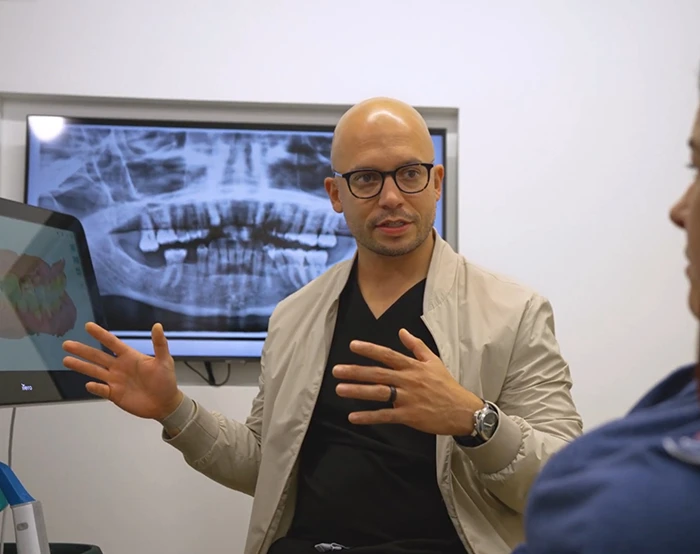 Dr. Silfa explaining an X-ray to a patient