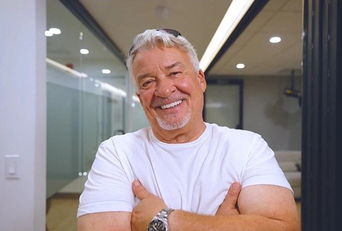 Greggory smiling with his arms crossed in the Silfa Dental office