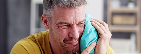 Some swelling and discomfort is normal following dental implant surgery but can be treated with cold or warm compresses