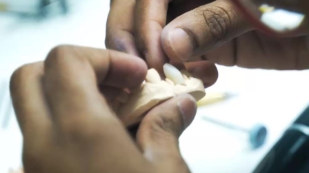 Ceramist designing a dental crown