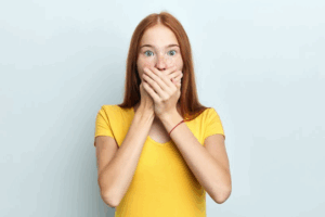 Woman covering her mouth in shock