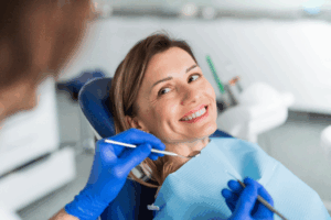 a patient smiling while visiting their dentist